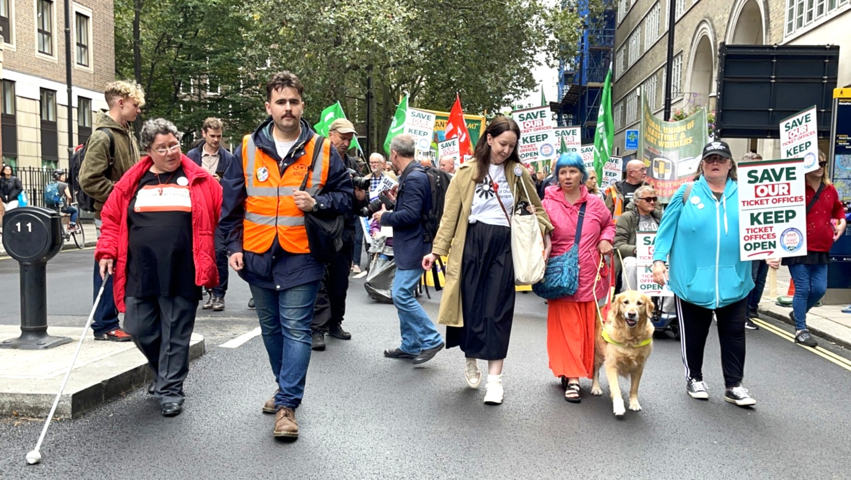 Image of disabled campaigners marching against ticket office closures in London, 2023.